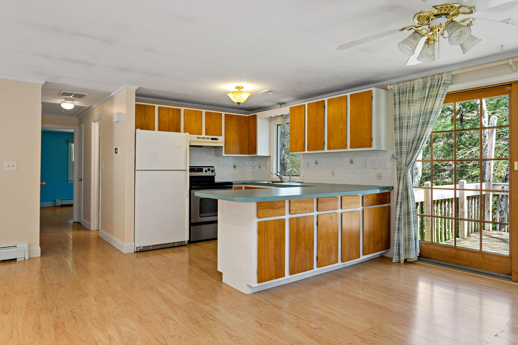 1092 Osterville West Barnstable Road Barnstable, MA 02648 - Photo 7 of 25 a kitchen with stainless steel appliances granite countertop a refrigerator a oven a sink with wooden cabinets and glass windows