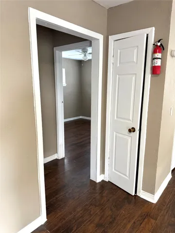 an empty room with wooden floor and closet