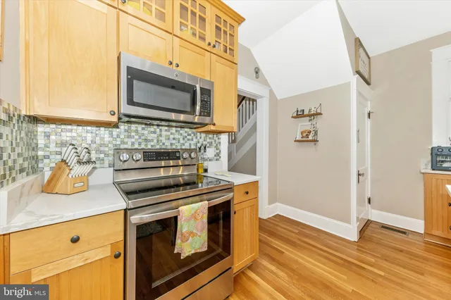 a kitchen with stainless steel appliances a stove and a microwave