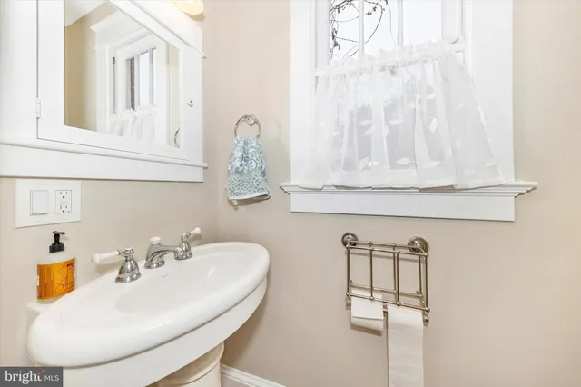 a bathroom with mirror and