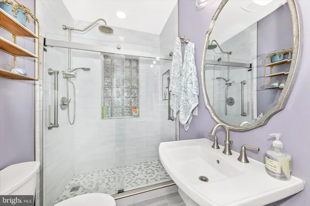 a bathroom with a sink toilet and shower