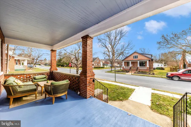 a living room with patio furniture and a large window