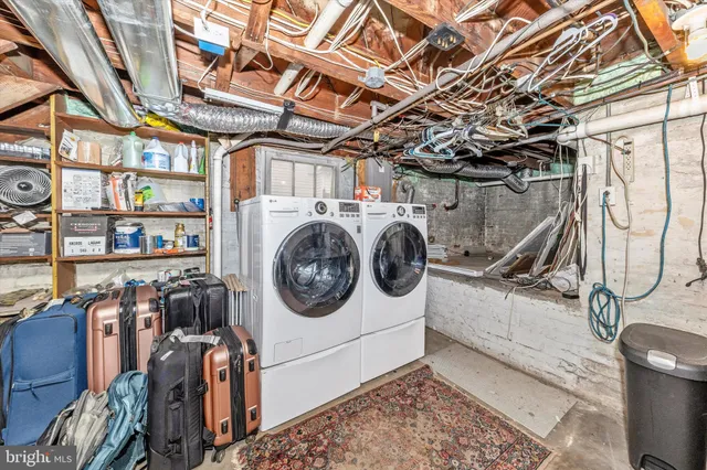 a utility room with dryer washer and stair