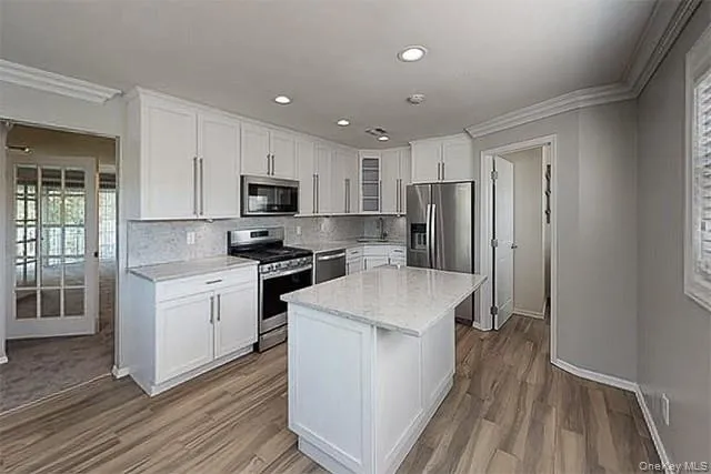a kitchen with wooden cabinets and stainless steel appliances