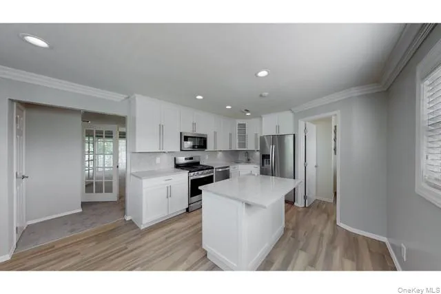 a open kitchen with cabinets stove and refrigerator