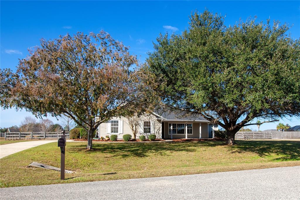 9910 Southwest 98th Terrace Gainesville, FL 32608 - Photo 1 of 1 a front view of a house with a garden and trees