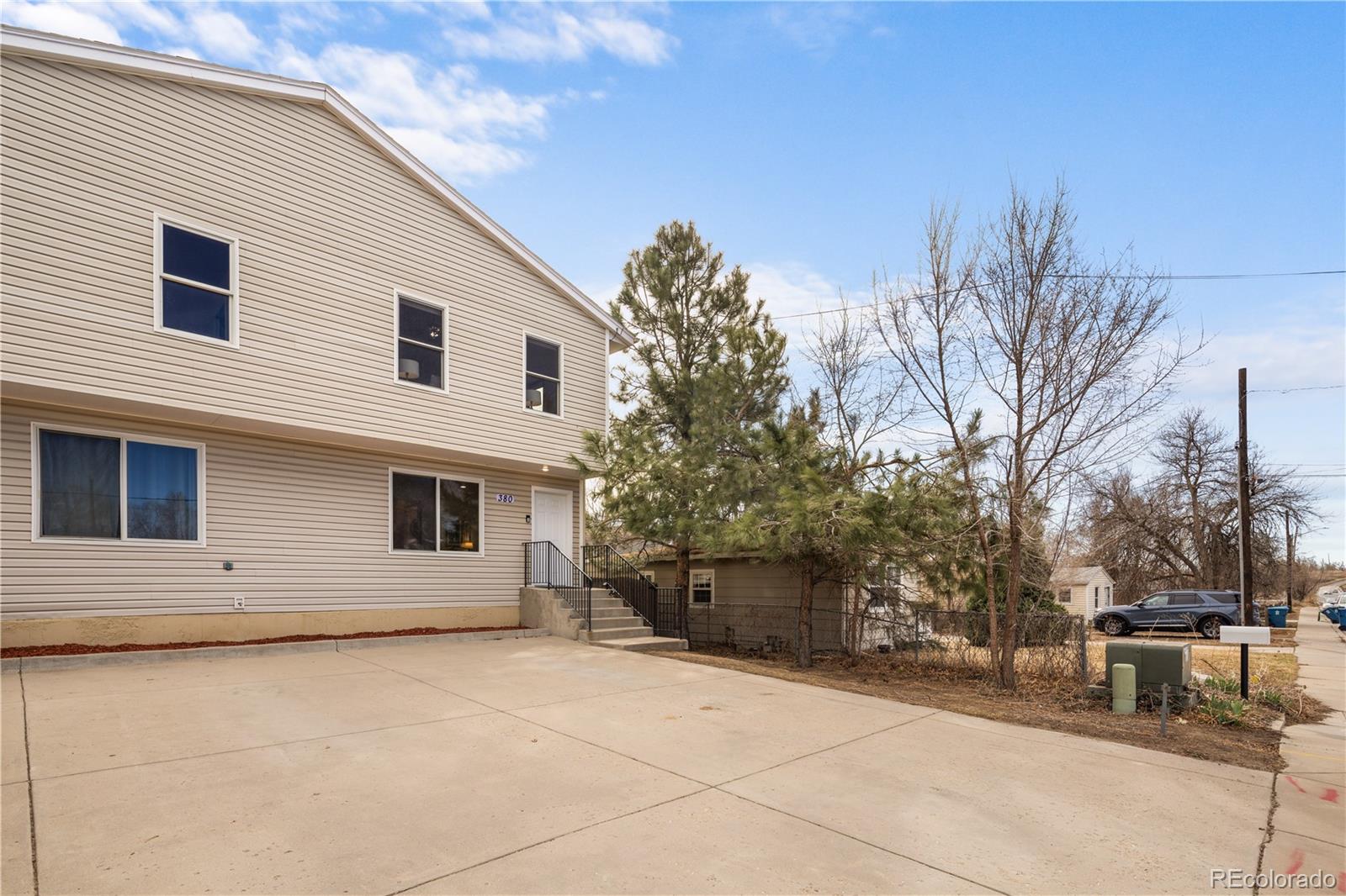 380 County Road Louisville, CO 80027 - Photo 35 of 42 a view of a white house with a yard