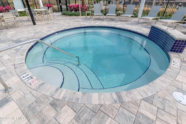 swimming pool view with a seating space