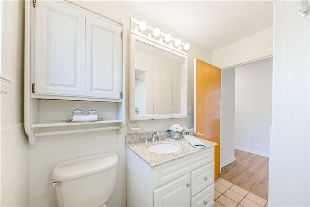 101 Lorish Road, Unit A McKees Rocks, PA 15136 - Photo 13 of 25 a bathroom with a sink a toilet and vanity