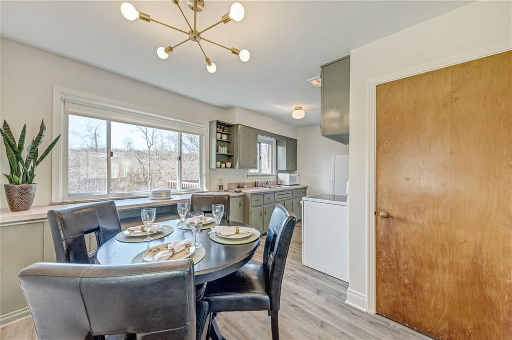 101 Lorish Road, Unit A McKees Rocks, PA 15136 - Photo 7 of 25 a dining room with furniture a large window and wooden floor