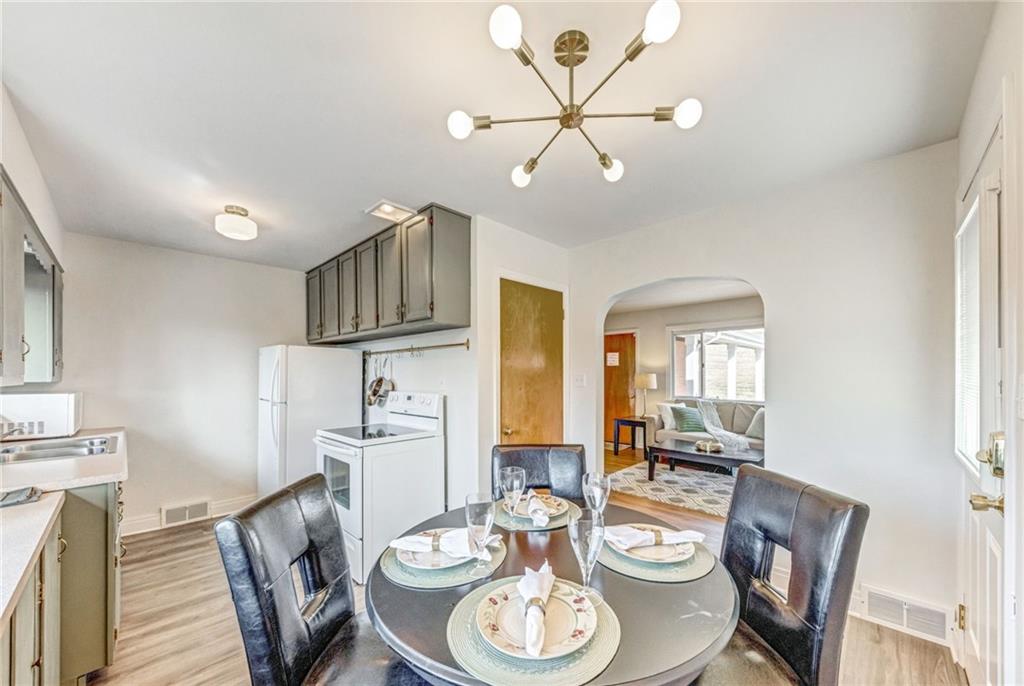 101 Lorish Road, Unit A McKees Rocks, PA 15136 - Photo 8 of 25 a kitchen with stainless steel appliances a dining table and chairs