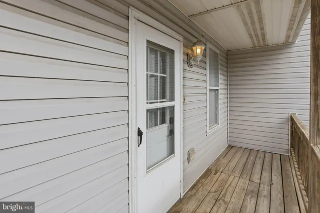 a view of a balcony with wooden floor and fence