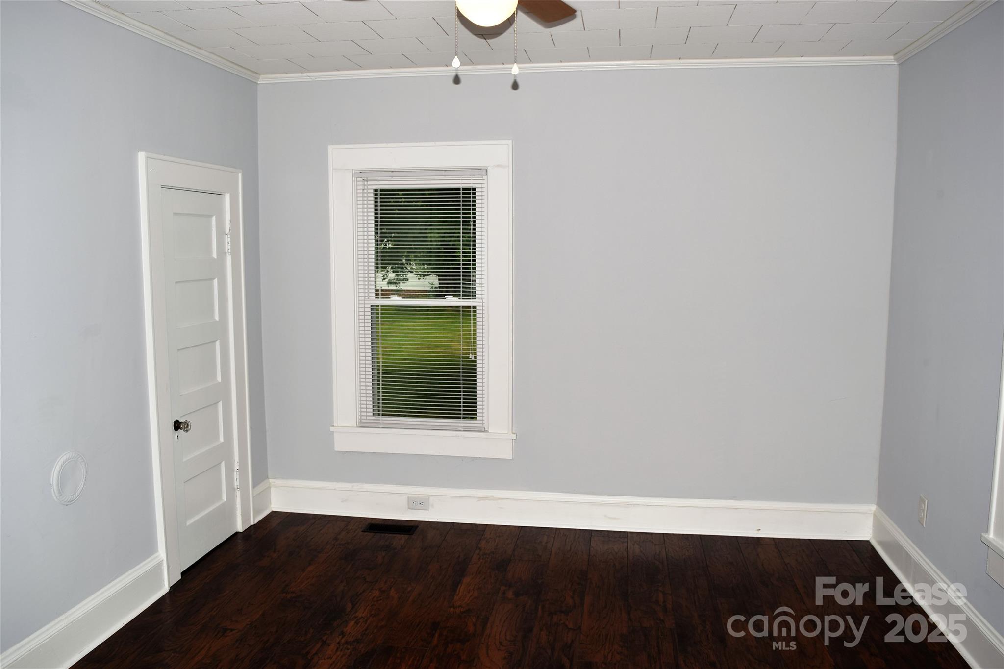 234 North Eastway Drive Troutman, NC 28166 - Photo 11 of 37 an empty room with wooden floor and windows