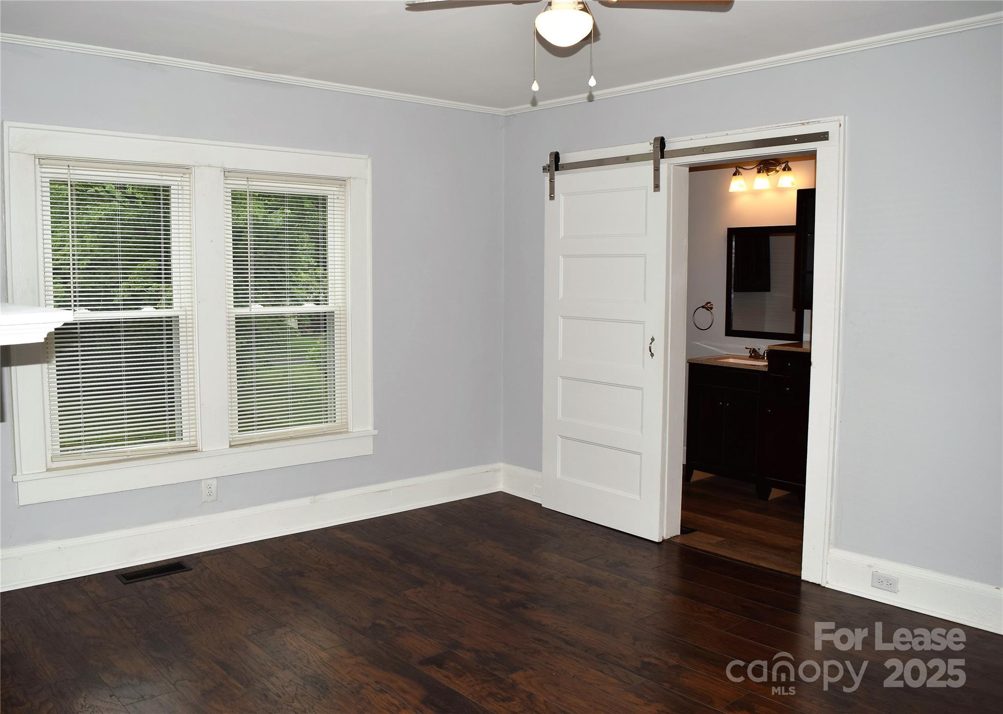 234 North Eastway Drive Troutman, NC 28166 - Photo 16 of 37 an empty room with wooden floor and windows