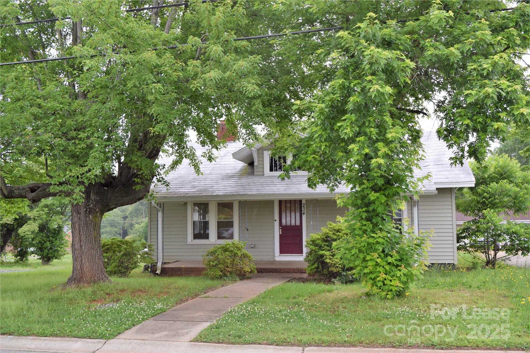 234 North Eastway Drive Troutman, NC 28166 - Photo 2 of 37 a front view of a house with a yard and potted plants