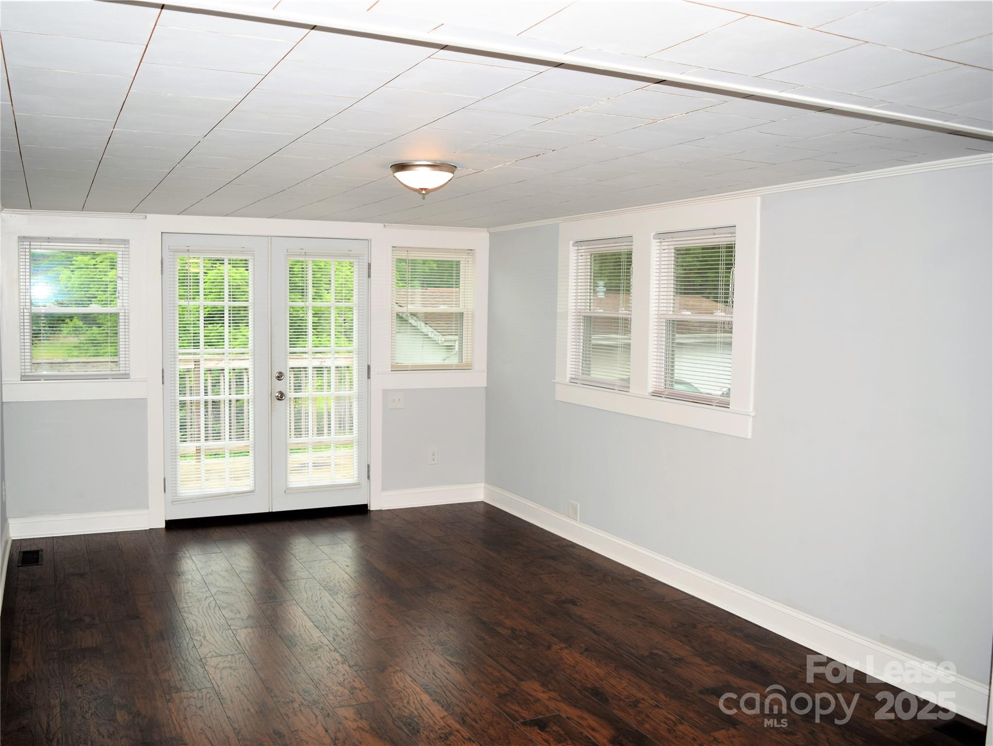 234 North Eastway Drive Troutman, NC 28166 - Photo 25 of 37 an empty room with wooden floor and windows