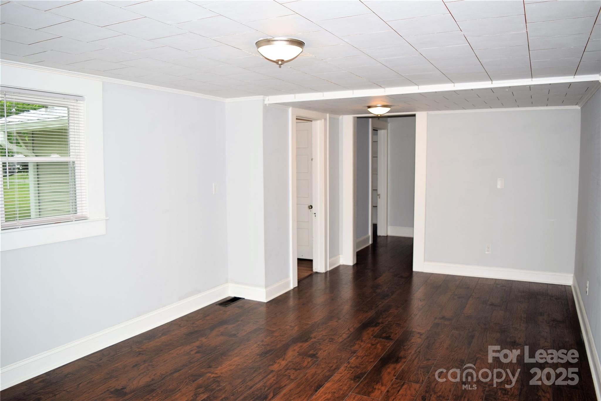 234 North Eastway Drive Troutman, NC 28166 - Photo 26 of 37 an empty room with wooden floor and windows