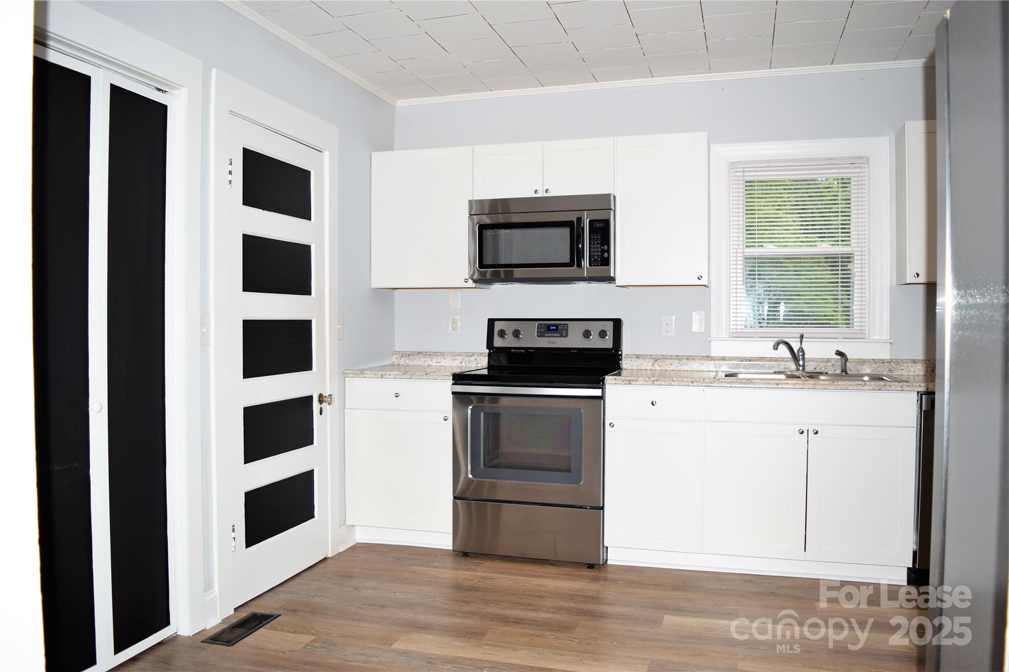 234 North Eastway Drive Troutman, NC 28166 - Photo 28 of 37 a kitchen with stainless steel appliances kitchen island granite countertop a sink and a stove top oven