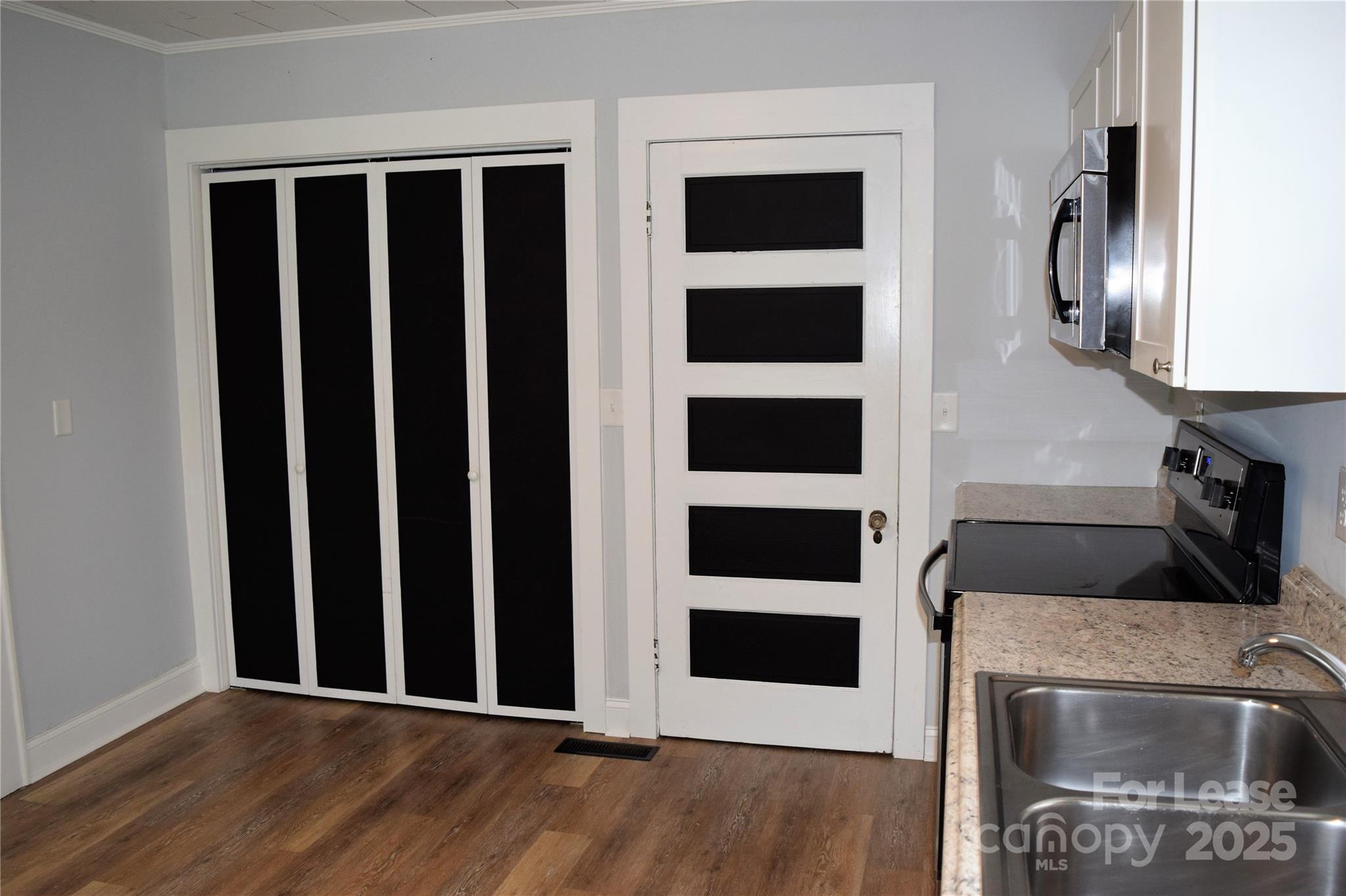 234 North Eastway Drive Troutman, NC 28166 - Photo 31 of 37 a view of a livingroom with wooden floor and white walls