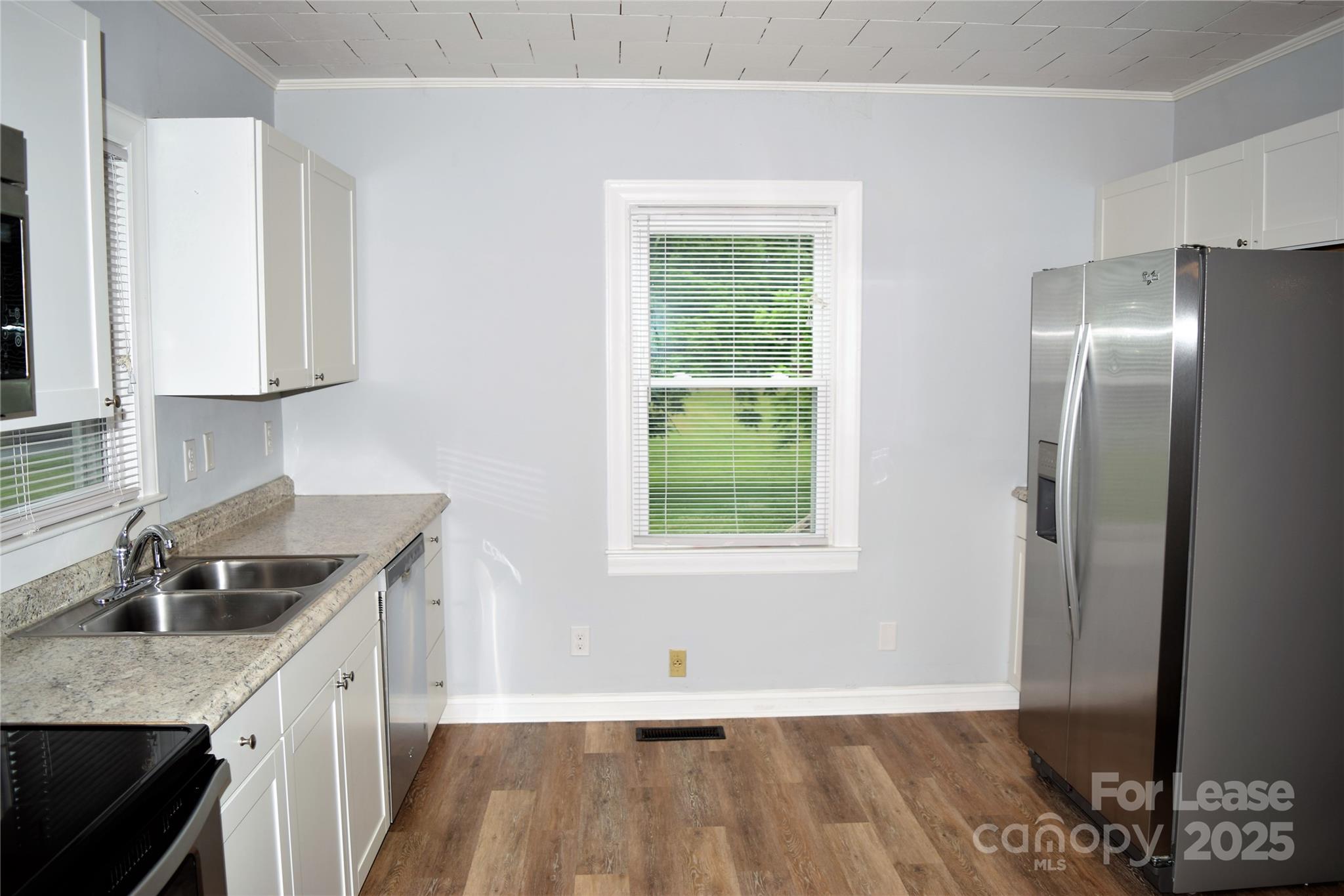 234 North Eastway Drive Troutman, NC 28166 - Photo 32 of 37 a kitchen with granite countertop a sink a counter space and cabinets