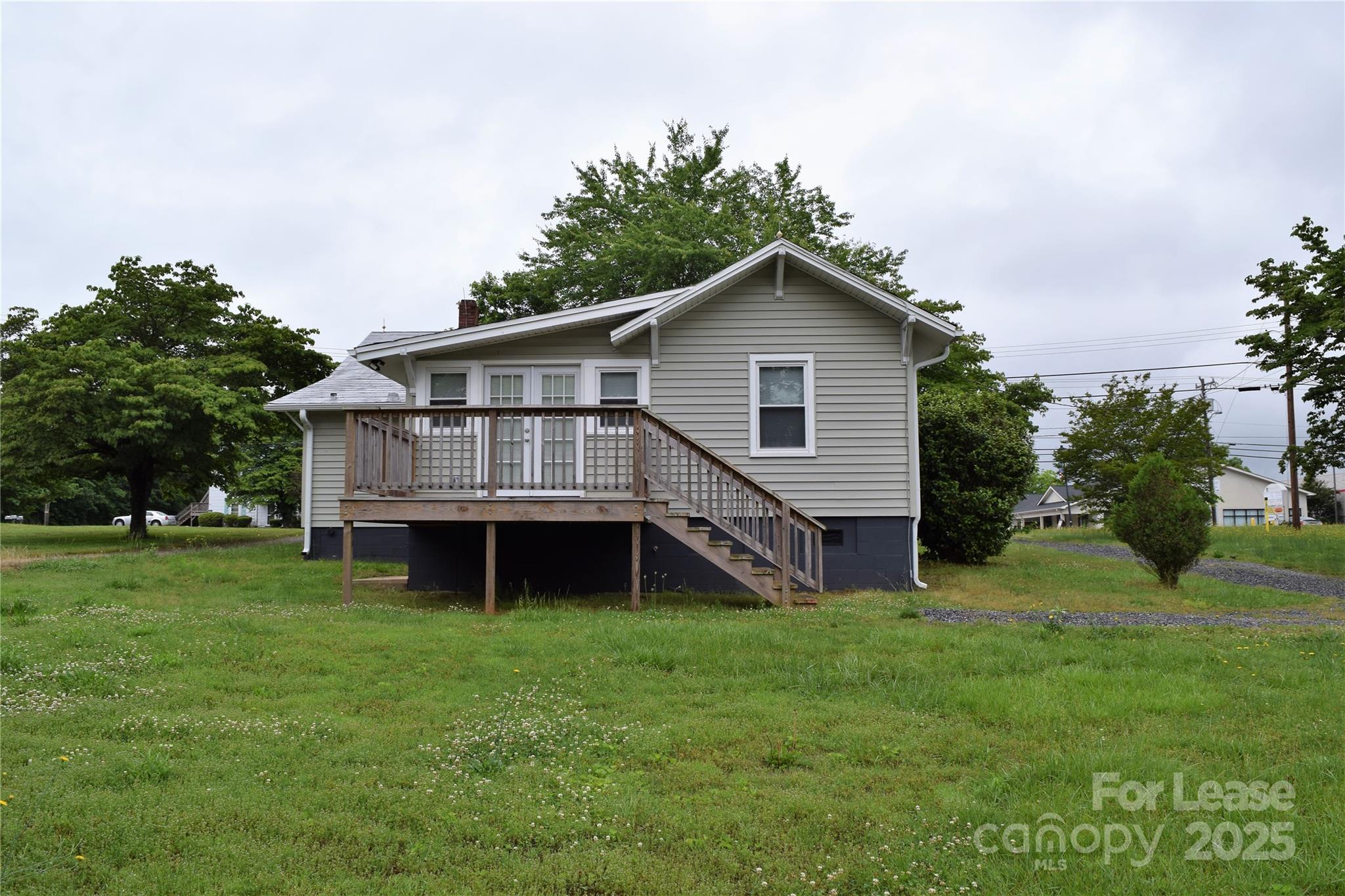234 North Eastway Drive Troutman, NC 28166 - Photo 36 of 37 a view of a house with a yard potted plants and a large tree