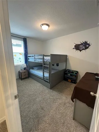 a bedroom with a bed and chair