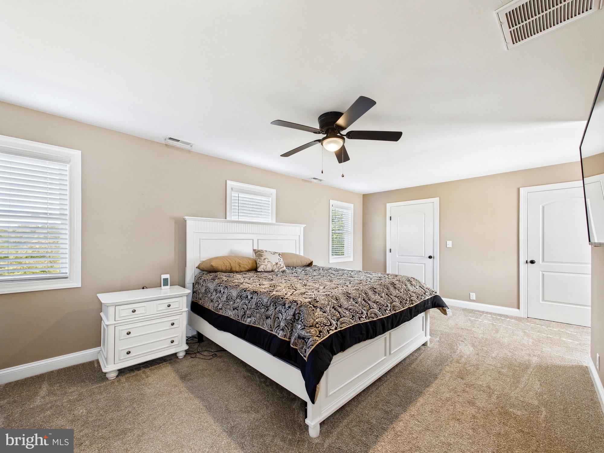 15551 Wharton Road Goldsboro, MD 21636 - Photo 29 of 80 a bedroom with a bed and a chandelier