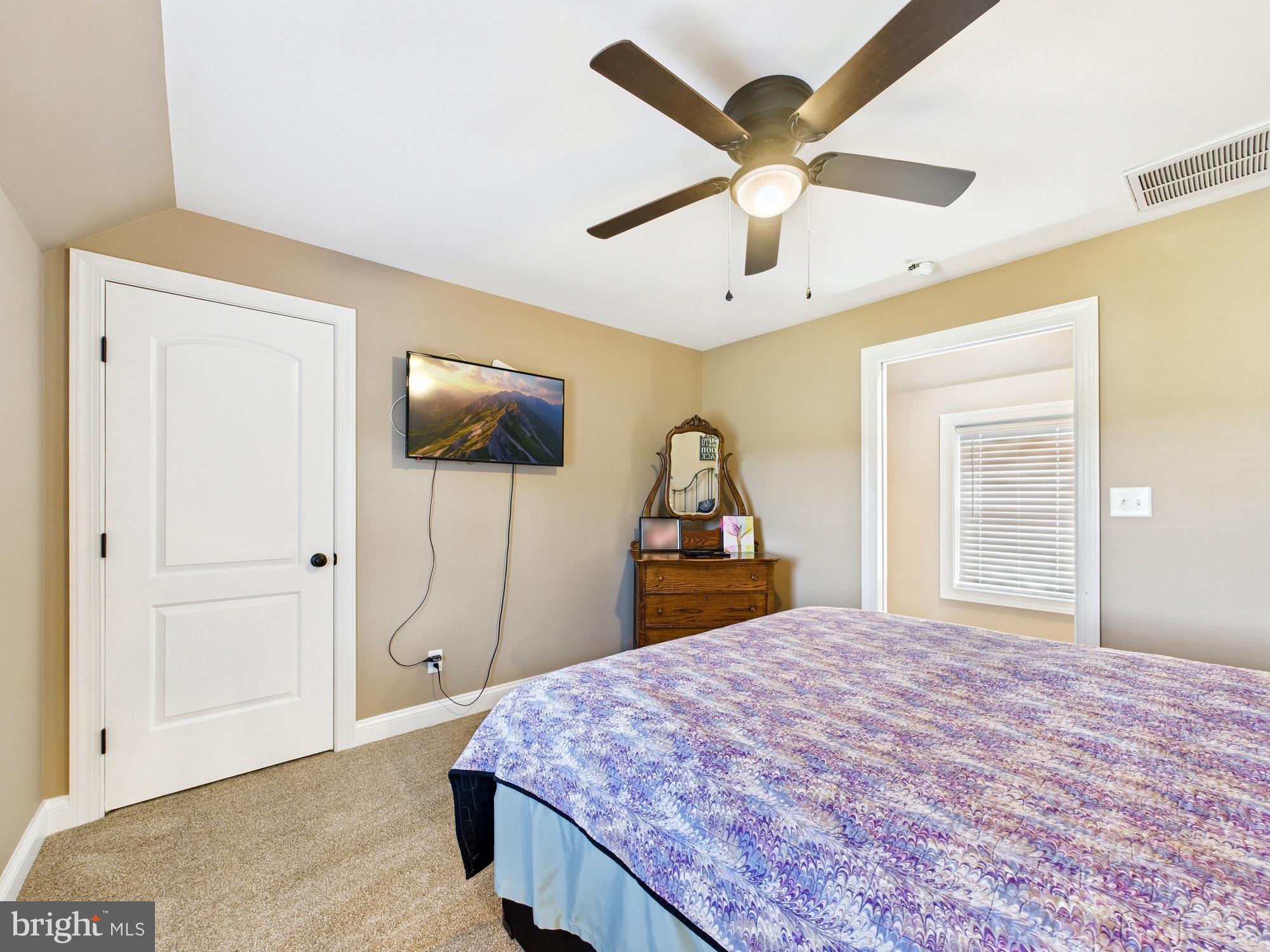 15551 Wharton Road Goldsboro, MD 21636 - Photo 38 of 80 a bedroom with a bed and a flat tv screen