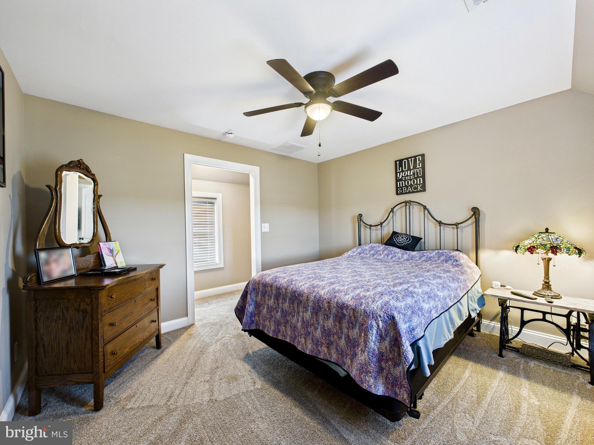 15551 Wharton Road Goldsboro, MD 21636 - Photo 43 of 80 a bedroom with a bed and a chandelier