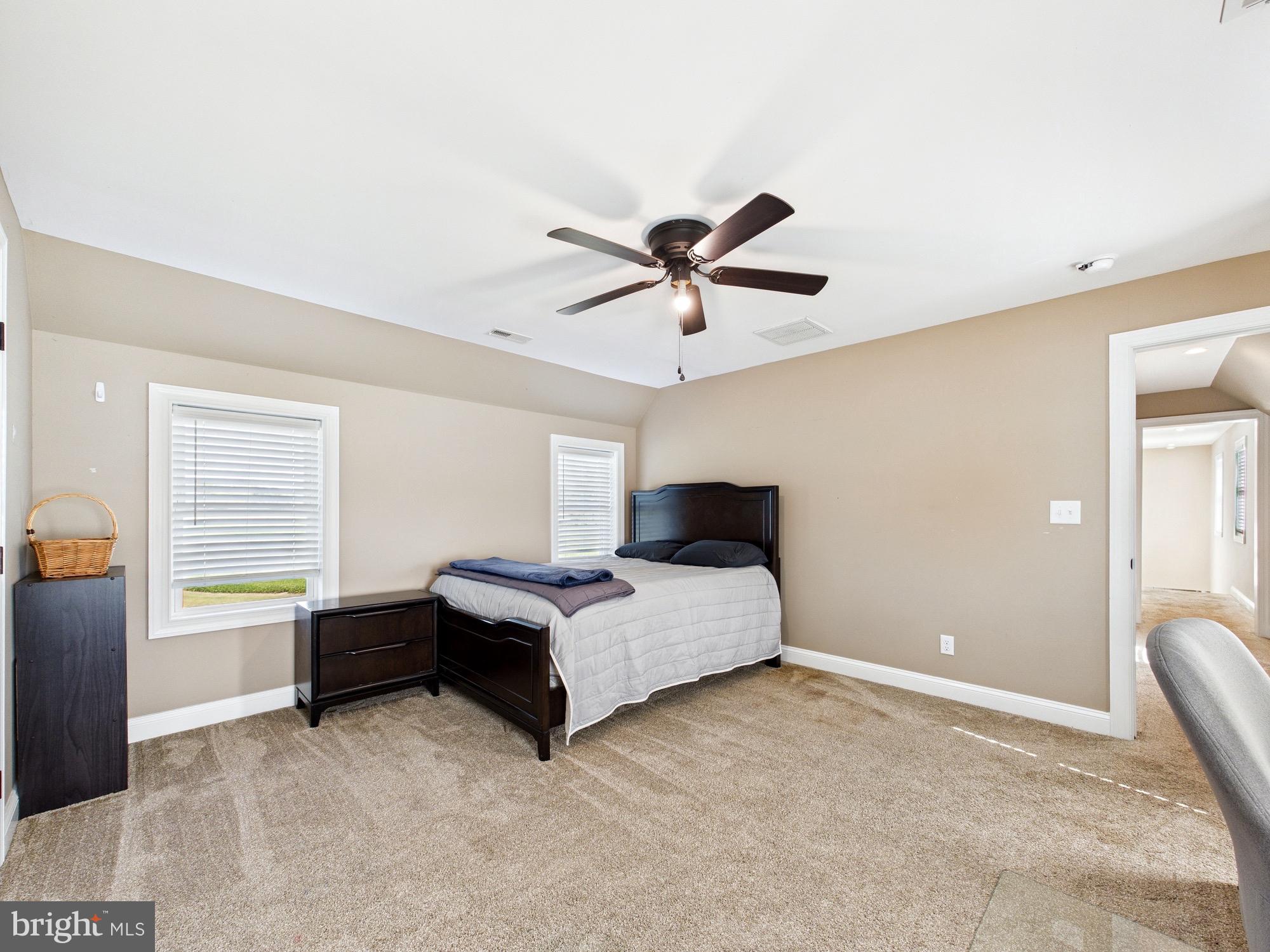 15551 Wharton Road Goldsboro, MD 21636 - Photo 45 of 80 a spacious bedroom with a bed and a ceiling fan