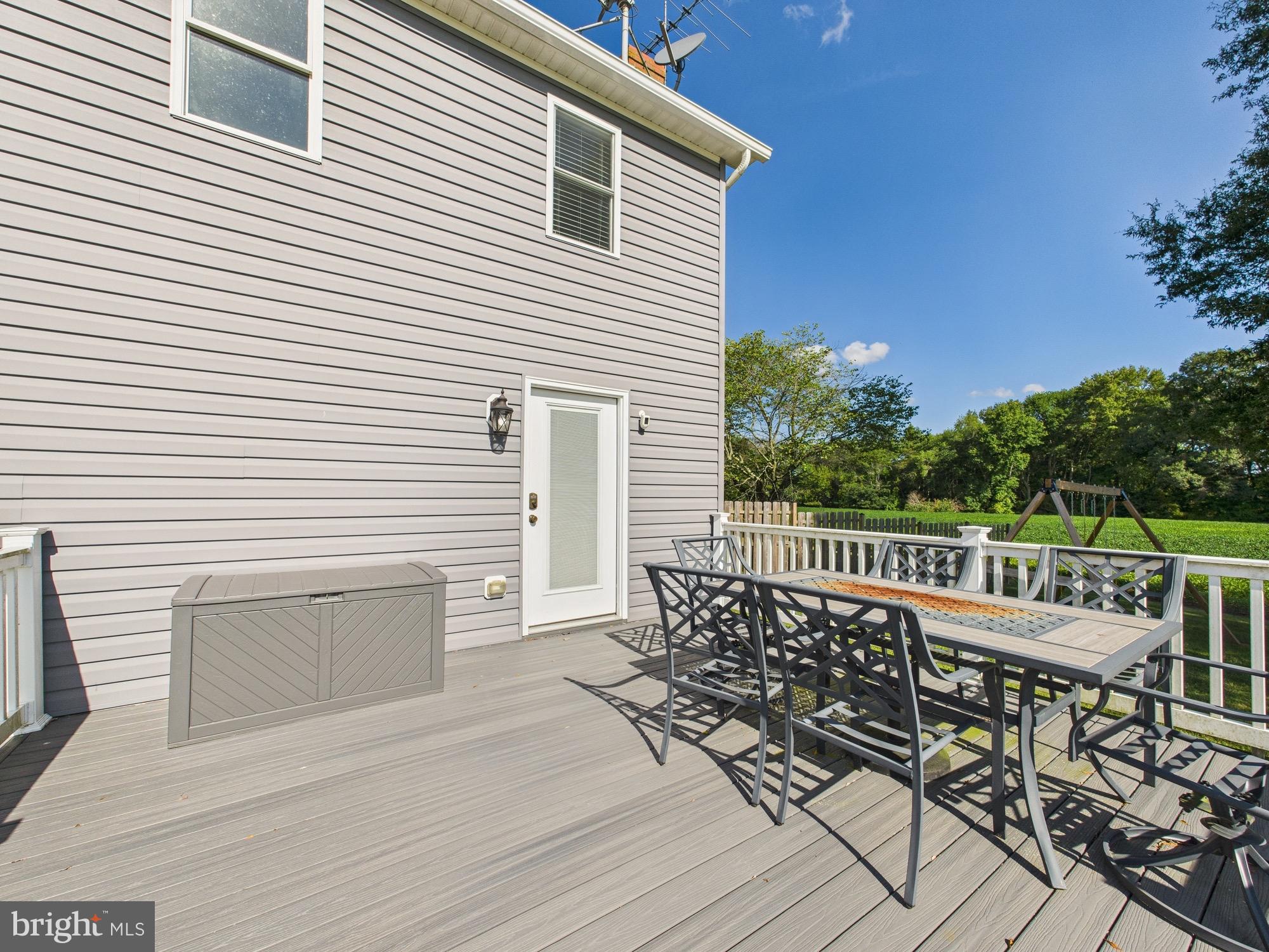 15551 Wharton Road Goldsboro, MD 21636 - Photo 70 of 80 a view of a roof deck with table and chairs a barbeque with wooden floor and fence