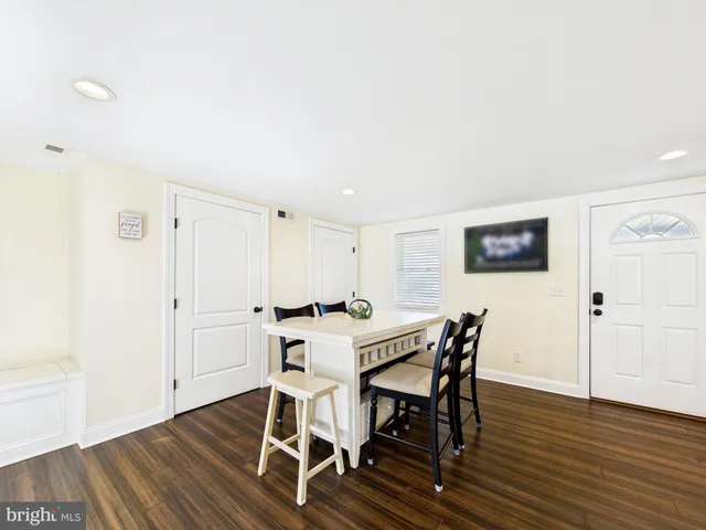 a kitchen with granite countertop a sink a stove and cabinets