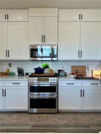 a kitchen with granite countertop a sink and cabinets