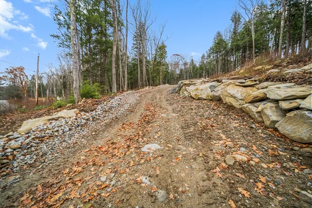 a view of a yard with wooden fence
