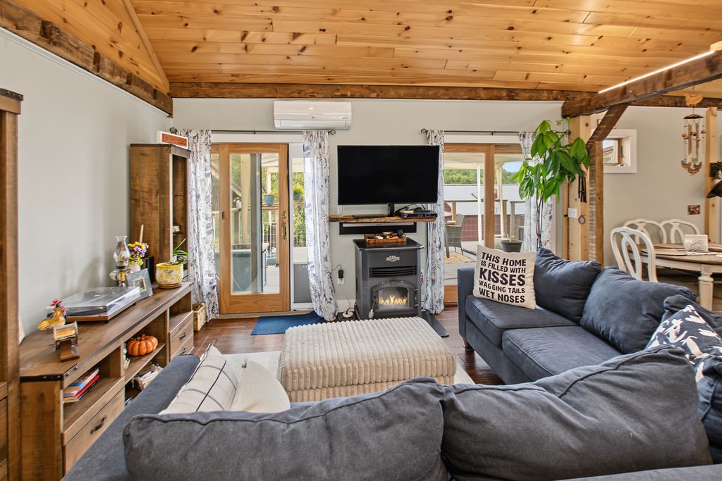 1668 Vandervort Hill Road Unadilla, NY 13849 - Photo 15 of 50 Rich wood plank ceilings and matching beams anchor this inviting open-concept living area.