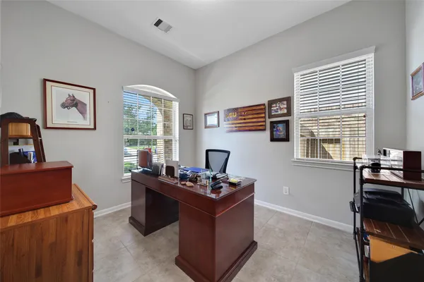 a living room with furniture a flat screen tv and a window