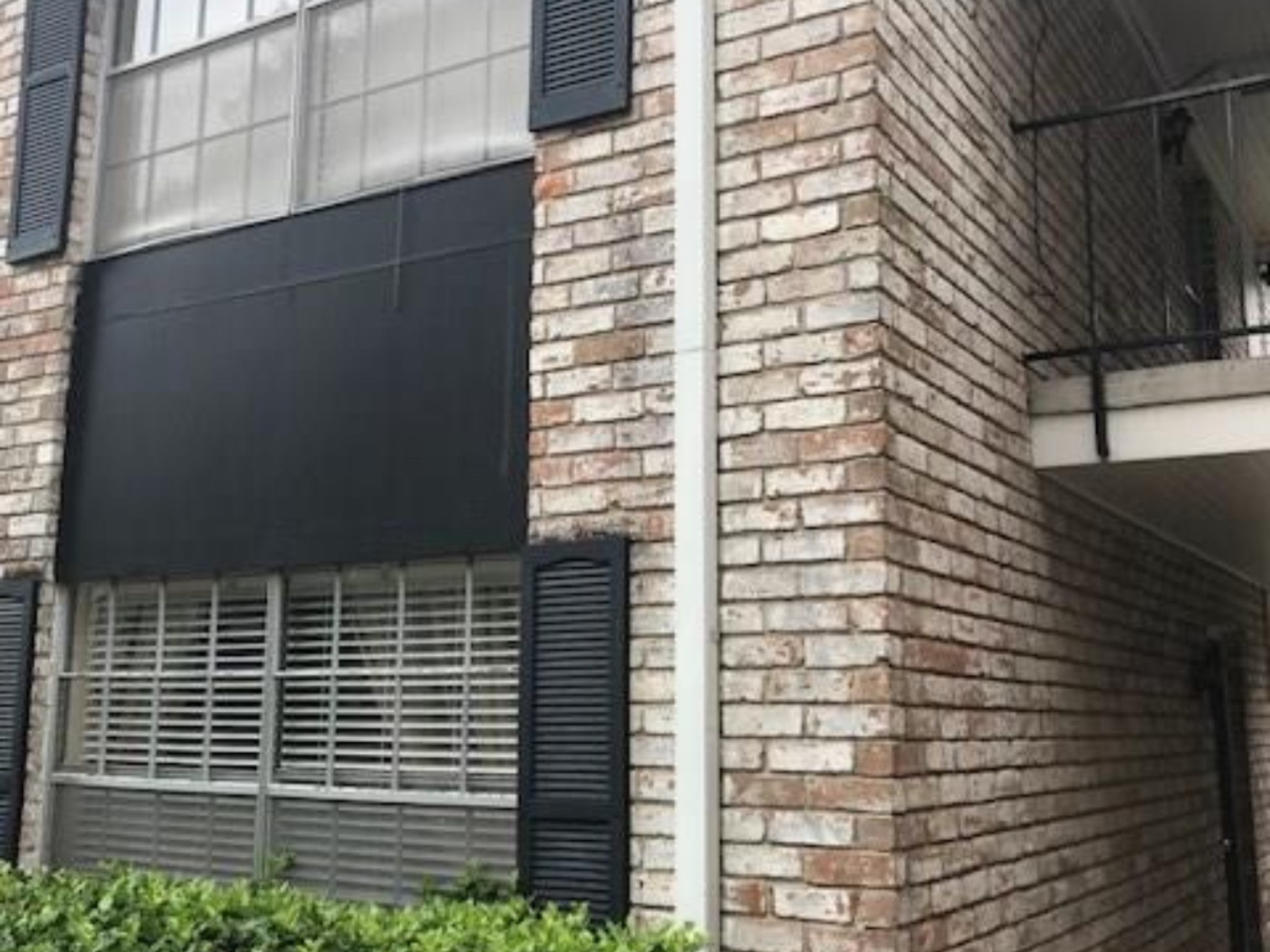 7900 Westheimer Road, Unit 112 Houston, TX 77063 - Photo 6 of 11 Classic brick architecture with black shutters and a gated front patio add timeless appeal.