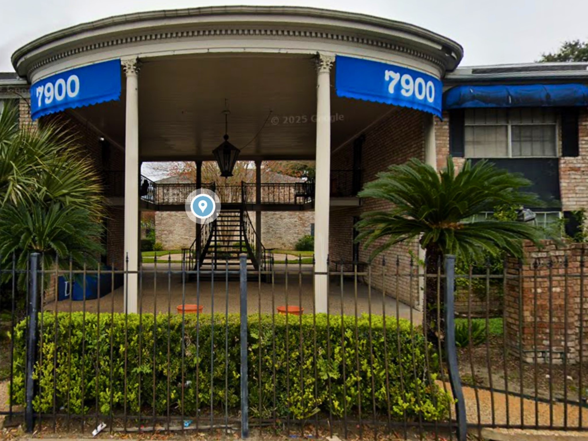 7900 Westheimer Road, Unit 112 Houston, TX 77063 - Photo 7 of 11 Welcoming grand entry with signature blue awnings and an elegant split staircase leading to your unit.