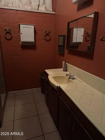 a bathroom with a sink and mirror