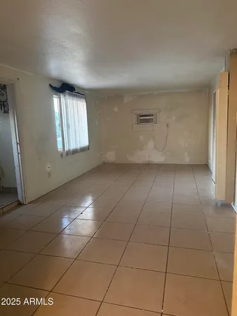 an empty room with a empty space and windows