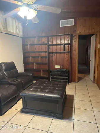 a living room with a couch and a chandelier