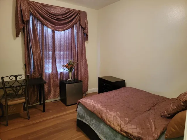 a bedroom with a bed and a mirror