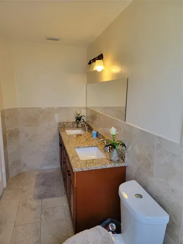 a bathroom with a sink toilet and mirror