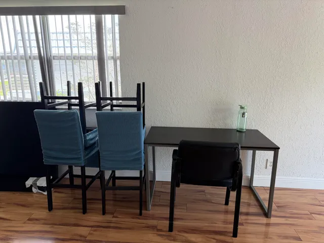 a dining room with furniture and wooden floor