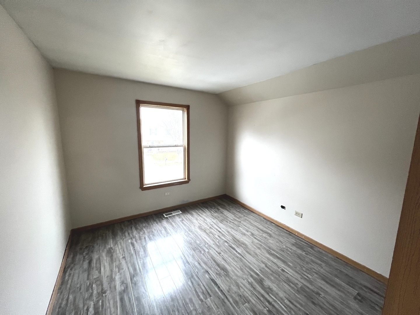 1301 Brookfield Drive Plainfield, IL 60586 - Photo 11 of 25 an empty room with wooden floor and windows
