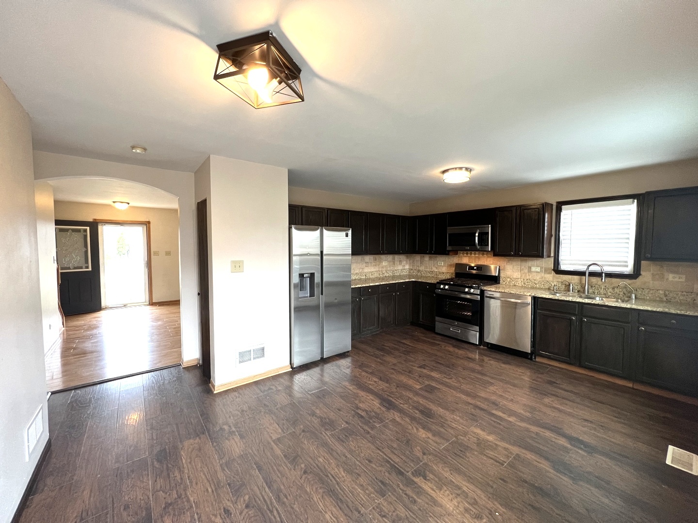 1301 Brookfield Drive Plainfield, IL 60586 - Photo 6 of 25 a large kitchen with a center island and stainless steel appliances