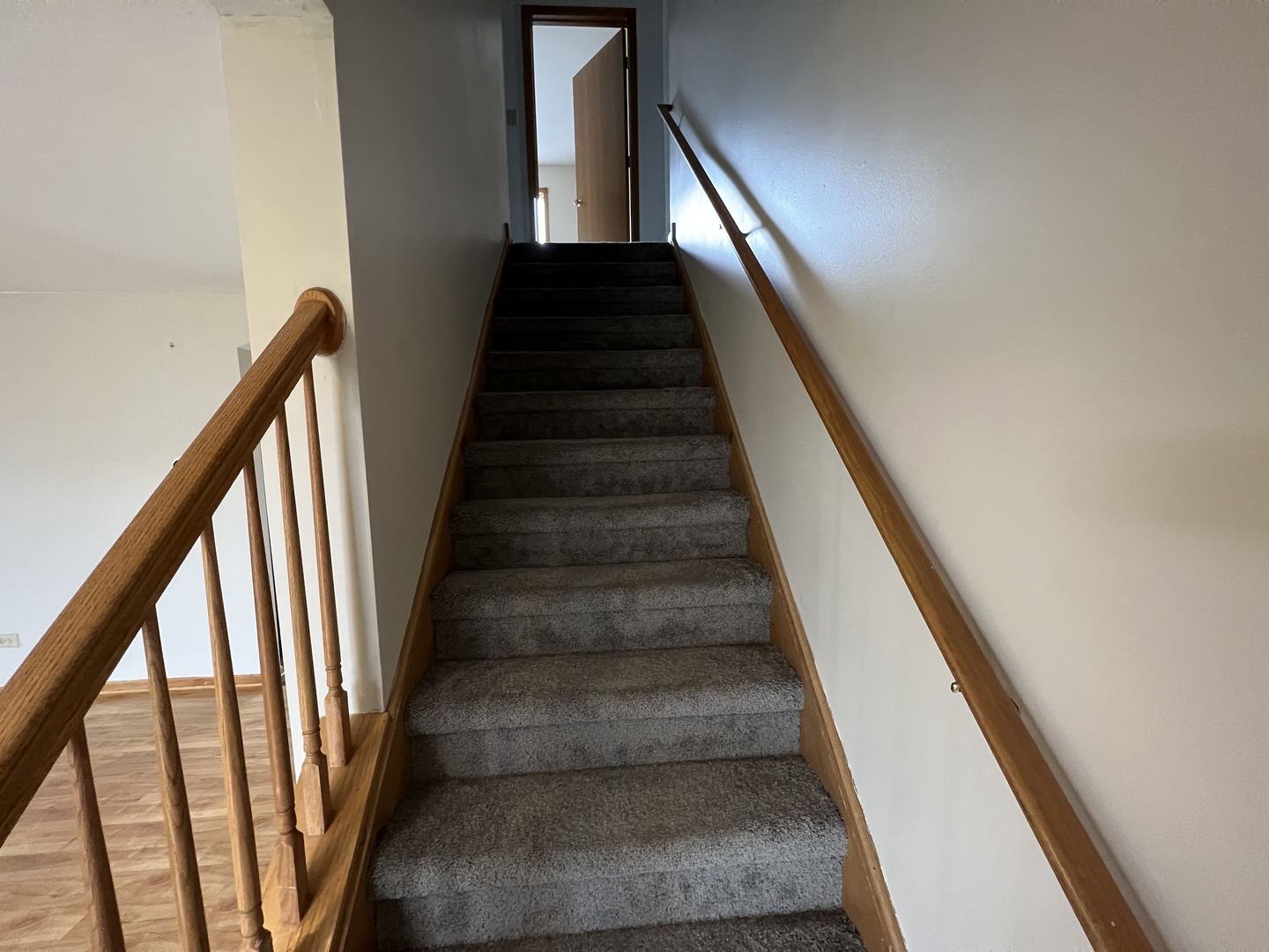 1301 Brookfield Drive Plainfield, IL 60586 - Photo 9 of 25 a view of staircase with wooden floor and white walls