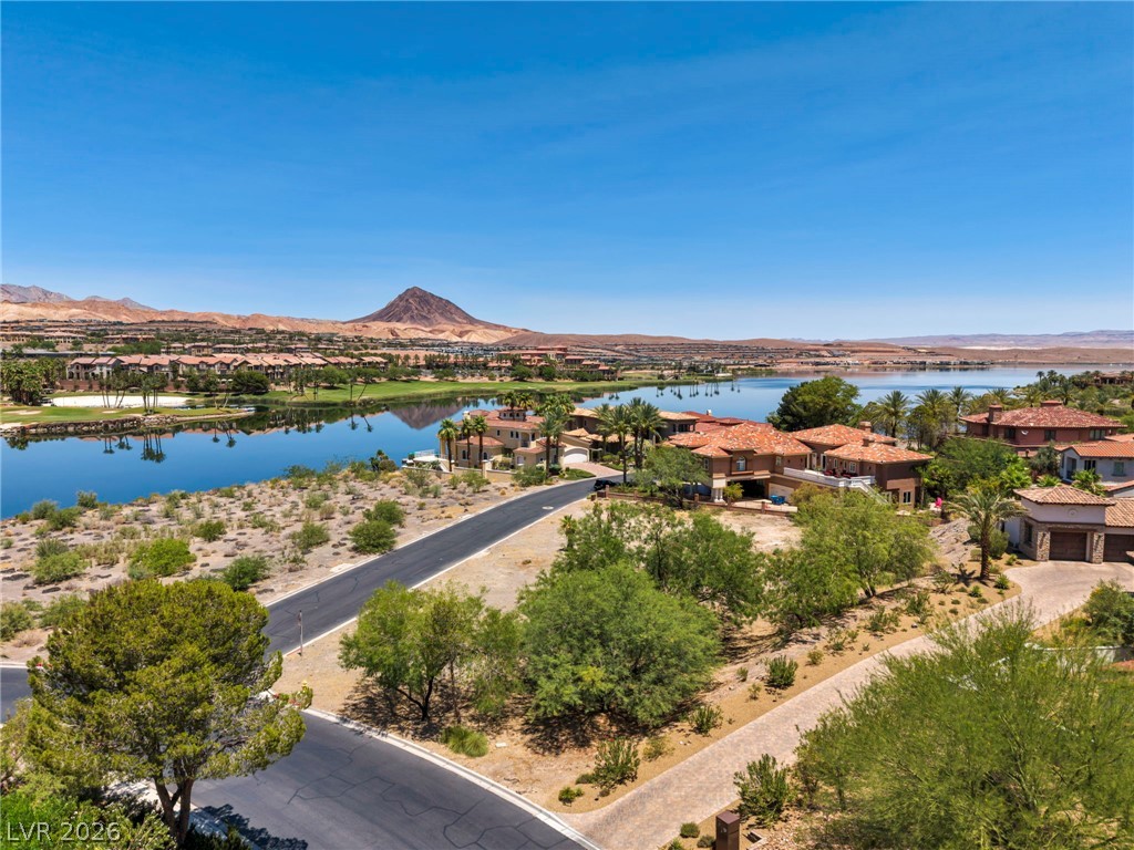3 Rue Promenade Way Henderson, NV 89011 - Photo 7 of 26 Perched above a serene lake, this expansive property offers commanding desert and mountain vistas.