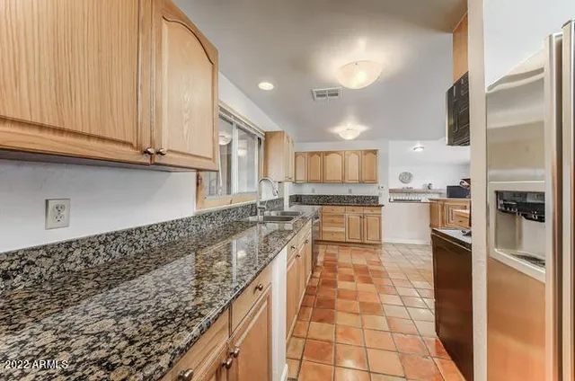a kitchen with stainless steel appliances granite countertop a sink and cabinets