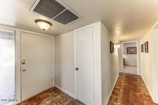 a view of a hallway with wooden floor and entryway